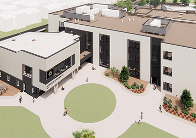 Aerial view of Horizon Uptown Aurora—a modern, three-story building with large windows, a central courtyard, landscaped areas, and people walking around the entrance. Discover Aurora CO new home communities and Horizon Uptown homes for sale.