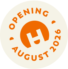 Orange circular logo with a stylized "H" in the center and text around it reading "Opening August 2026." Discover new construction homes in Aurora, CO at Horizon Uptown—homes for sale coming soon!.