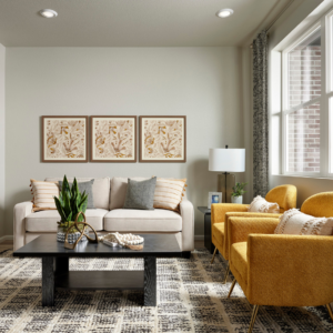 Modern living room with a beige sofa, two yellow armchairs, a black coffee table, patterned rug, and three framed artworks on a neutral wall. Large window lets in natural light.